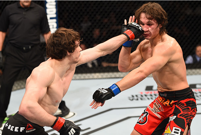 MONTREAL, QC - APRIL 25:   (L-R) Olivier Aubin-Mercier of Canada punches David Michaud of the United States in their lightweight bout during the UFC 186 event at the Bell Centre on April 25, 2015 in Montreal, Quebec, Canada. (Photo by Josh Hedges/Zuffa LL