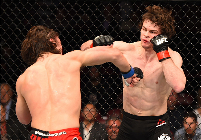 MONTREAL, QC - APRIL 25:   (L-R) David Michaud of the United States punches Olivier Aubin-Mercier of Canada in their lightweight bout during the UFC 186 event at the Bell Centre on April 25, 2015 in Montreal, Quebec, Canada. (Photo by Josh Hedges/Zuffa LL