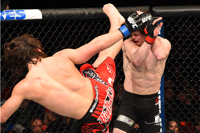 MONTREAL, QC - APRIL 25:   (L-R) David Michaud of the United States kicks Olivier Aubin-Mercier of Canada in their lightweight bout during the UFC 186 event at the Bell Centre on April 25, 2015 in Montreal, Quebec, Canada. (Photo by Josh Hedges/Zuffa LLC/