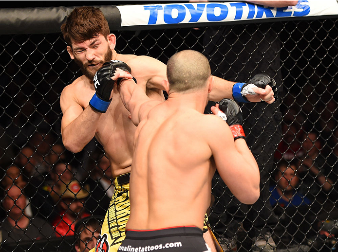 MONTREAL, QC - APRIL 25:  (R-L) Chad Laprise of Canada punches Bryan Barberena of the United States in their lightweight bout during the UFC 186 event at the Bell Centre on April 25, 2015 in Montreal, Quebec, Canada. (Photo by Josh Hedges/Zuffa LLC/Zuffa 