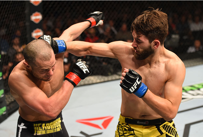 MONTREAL, QC - APRIL 25:   (R-L) Bryan Barberena of the United States punches Chad Laprise of Canada in their lightweight bout during the UFC 186 event at the Bell Centre on April 25, 2015 in Montreal, Quebec, Canada. (Photo by Josh Hedges/Zuffa LLC/Zuffa