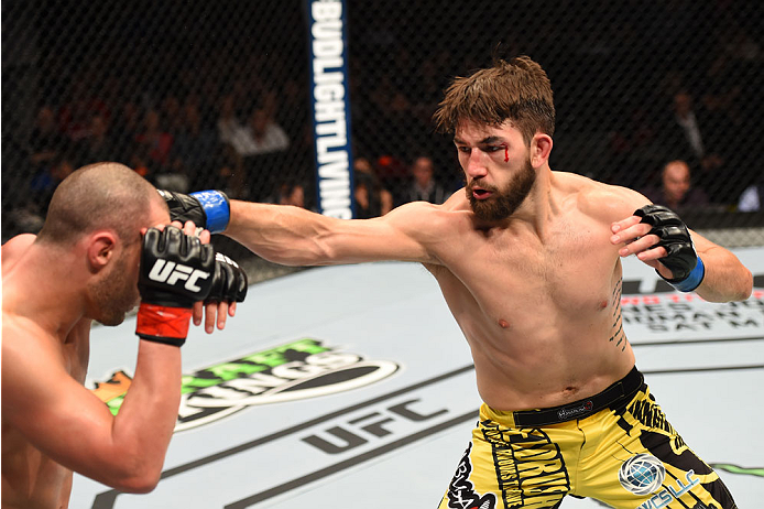 MONTREAL, QC - APRIL 25:   (R-L) Bryan Barberena of the United States punches Chad Laprise of Canada in their lightweight bout during the UFC 186 event at the Bell Centre on April 25, 2015 in Montreal, Quebec, Canada. (Photo by Josh Hedges/Zuffa LLC/Zuffa