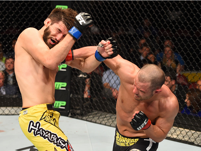 MONTREAL, QC - APRIL 25:  (R-L) Chad Laprise of Canada punches Bryan Barberena of the United States in their lightweight bout during the UFC 186 event at the Bell Centre on April 25, 2015 in Montreal, Quebec, Canada. (Photo by Josh Hedges/Zuffa LLC/Zuffa 