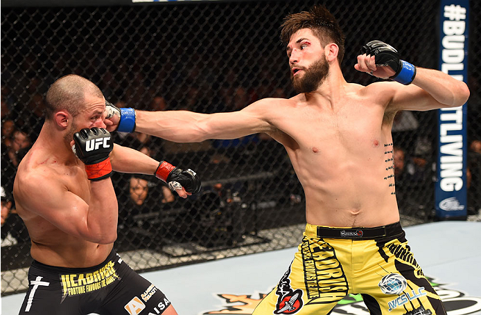 MONTREAL, QC - APRIL 25:   (R-L) Bryan Barberena of the United States punches Chad Laprise of Canada in their lightweight bout during the UFC 186 event at the Bell Centre on April 25, 2015 in Montreal, Quebec, Canada. (Photo by Josh Hedges/Zuffa LLC/Zuffa