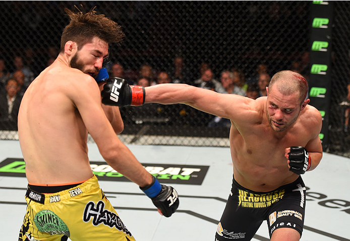 MONTREAL, QC - APRIL 25:   (R-L) Chad Laprise of Canada punches Bryan Barberena of the United States in their lightweight bout during the UFC 186 event at the Bell Centre on April 25, 2015 in Montreal, Quebec, Canada. (Photo by Josh Hedges/Zuffa LLC/Zuffa