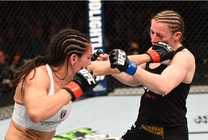 MONTREAL, QC - APRIL 25:   (L-R) Alexis Davis of Canada punches Sarah Kaufman of Canada in their women's bantamweight bout during the UFC 186 event at the Bell Centre on April 25, 2015 in Montreal, Quebec, Canada. (Photo by Josh Hedges/Zuffa LLC/Zuffa LLC