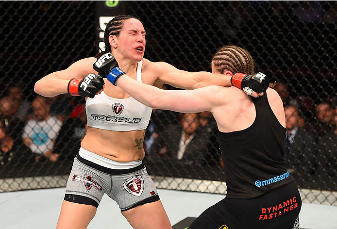 MONTREAL, QC - APRIL 25:   (R-L) Sarah Kaufman of Canada and Alexis Davis of Canada trade punches in their women's bantamweight bout during the UFC 186 event at the Bell Centre on April 25, 2015 in Montreal, Quebec, Canada. (Photo by Josh Hedges/Zuffa LLC