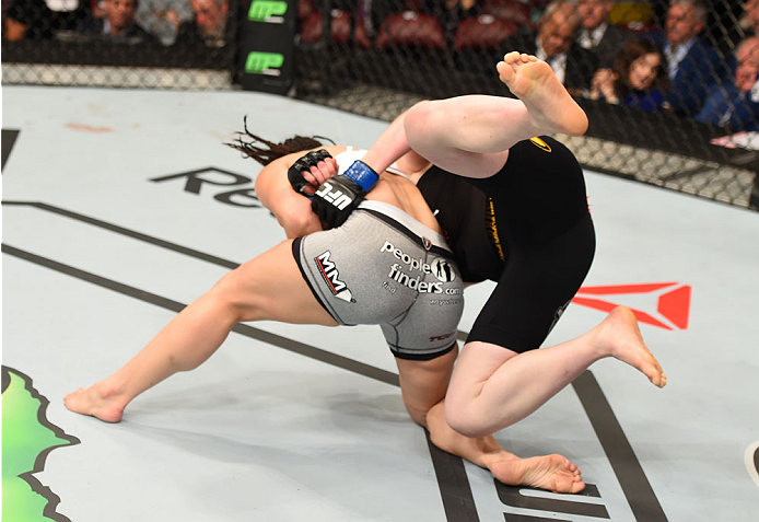 MONTREAL, QC - APRIL 25:   (L-R) Alexis Davis of Canada throws Sarah Kaufman of Canada to the mat in their women's bantamweight bout during the UFC 186 event at the Bell Centre on April 25, 2015 in Montreal, Quebec, Canada. (Photo by Josh Hedges/Zuffa LLC