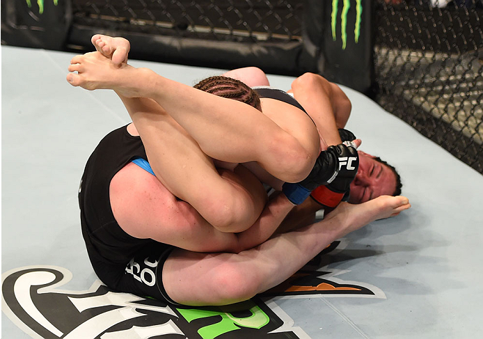 MONTREAL, QC - APRIL 25: (R-L) Alexis Davis of Canada secures an arm bar submission against Sarah Kaufman of Canada in their women's bantamweight bout during the UFC 186 event at the Bell Centre on April 25, 2015 in Montreal, Quebec, Canada. (Photo by J