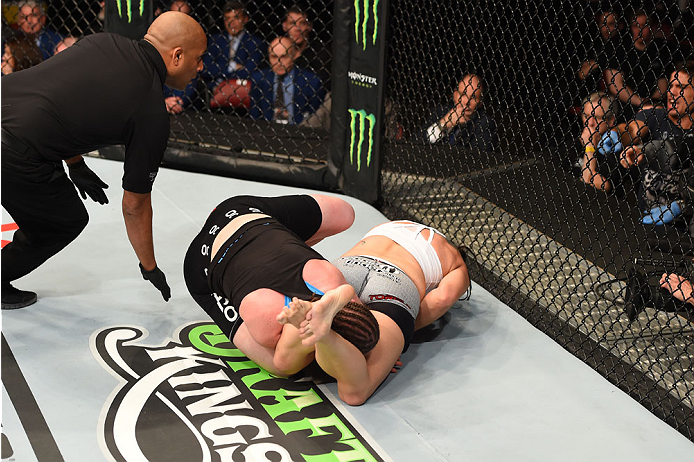 MONTREAL, QC - APRIL 25: (R-L) Alexis Davis of Canada secures an arm bar submission against Sarah Kaufman of Canada in their women's bantamweight bout during the UFC 186 event at the Bell Centre on April 25, 2015 in Montreal, Quebec, Canada. (Photo by J