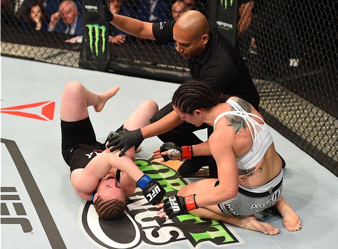 MONTREAL, QC - APRIL 25:   (R-L) Alexis Davis of Canada checks on opponent Sarah Kaufman of Canada after her submission victory in their women's bantamweight bout during the UFC 186 event at the Bell Centre on April 25, 2015 in Montreal, Quebec, Canada. (