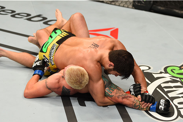 MONTREAL, QC - APRIL 25:   (R-L) Patrick Cote of Canada attempts an arm lock submission against Joe Riggs of the United Sates in their welterweight bout during the UFC 186 event at the Bell Centre on April 25, 2015 in Montreal, Quebec, Canada. (Photo by J