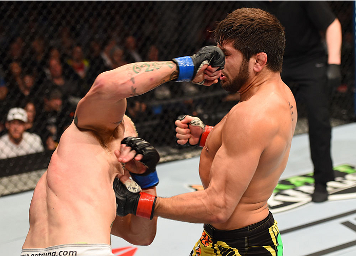 MONTREAL, QC - APRIL 25:   (R-L) Patrick Cote of Canada and Joe Riggs of the United Sates trade punches in their welterweight bout during the UFC 186 event at the Bell Centre on April 25, 2015 in Montreal, Quebec, Canada. (Photo by Josh Hedges/Zuffa LLC/Z