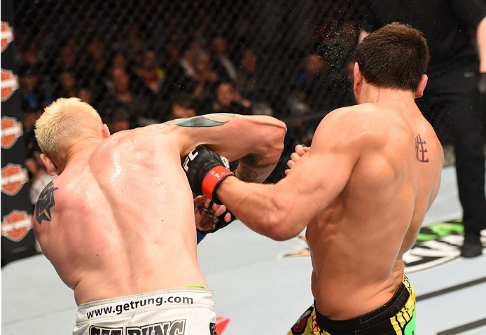 MONTREAL, QC - APRIL 25:   (L-R) Joe Riggs of the United Sates punches Patrick Cote of Canada in their welterweight bout during the UFC 186 event at the Bell Centre on April 25, 2015 in Montreal, Quebec, Canada. (Photo by Josh Hedges/Zuffa LLC/Zuffa LLC v