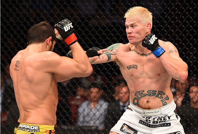 MONTREAL, QC - APRIL 25:   (R-L) Joe Riggs of the United Sates punches Patrick Cote of Canada in their welterweight bout during the UFC 186 event at the Bell Centre on April 25, 2015 in Montreal, Quebec, Canada. (Photo by Josh Hedges/Zuffa LLC/Zuffa LLC v