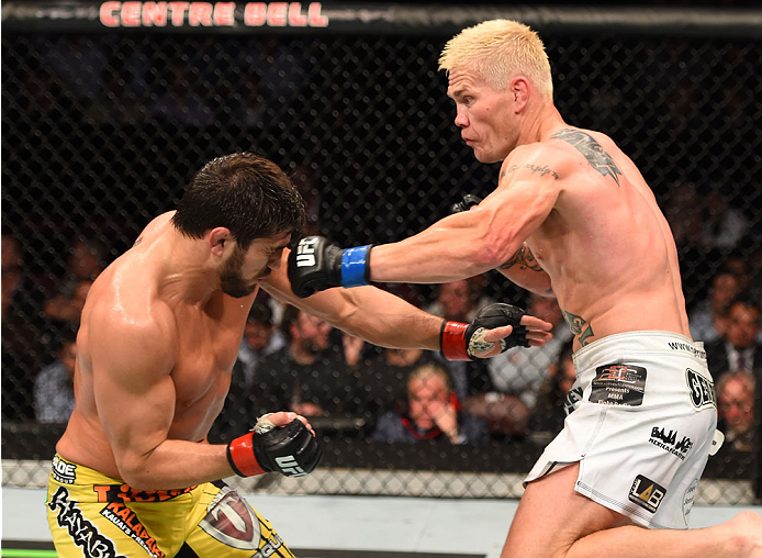 MONTREAL, QC - APRIL 25:   (R-L) Joe Riggs of the United Sates punches Patrick Cote of Canada in their welterweight bout during the UFC 186 event at the Bell Centre on April 25, 2015 in Montreal, Quebec, Canada. (Photo by Josh Hedges/Zuffa LLC/Zuffa LLC v