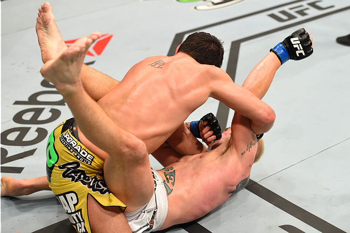 MONTREAL, QC - APRIL 25:   (L-R) Patrick Cote of Canada punches Joe Riggs of the United Sates in their welterweight bout during the UFC 186 event at the Bell Centre on April 25, 2015 in Montreal, Quebec, Canada. (Photo by Josh Hedges/Zuffa LLC/Zuffa LLC v