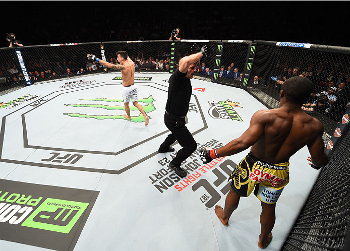 MONTREAL, QC - APRIL 25:   Thomas Almeida (L) of Brazil reacts after his TKO victory over Yves Jabouin of Canada in their bantamweight bout during the UFC 186 event at the Bell Centre on April 25, 2015 in Montreal, Quebec, Canada. (Photo by Josh Hedges/Zu