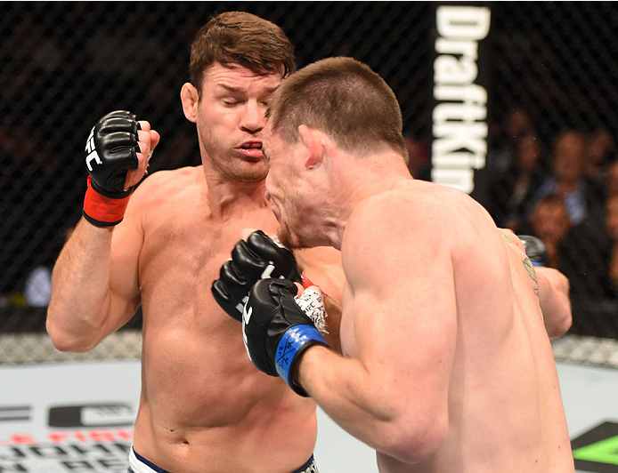 MONTREAL, QC - APRIL 25:   (L-R) Michael Bisping of England punches CB Dollaway of the United States in their middleweight bout during the UFC 186 event at the Bell Centre on April 25, 2015 in Montreal, Quebec, Canada. (Photo by Josh Hedges/Zuffa LLC/Zuff