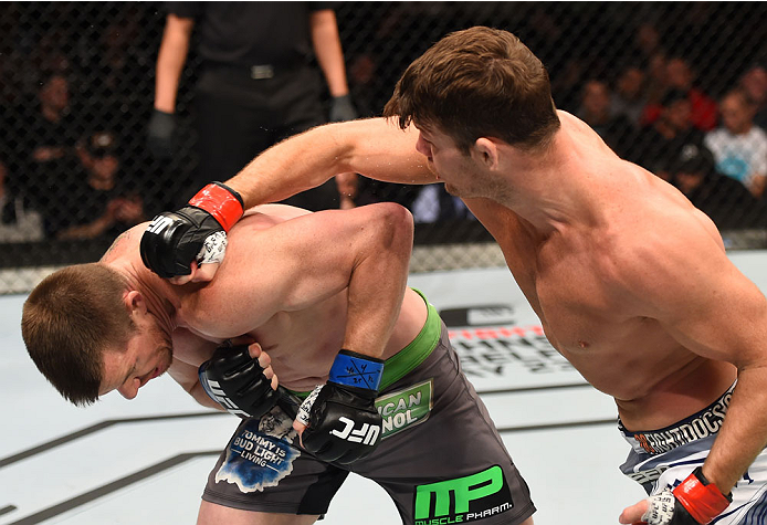 MONTREAL, QC - APRIL 25:   (R-L) Michael Bisping of England punches CB Dollaway of the United States in their middleweight bout during the UFC 186 event at the Bell Centre on April 25, 2015 in Montreal, Quebec, Canada. (Photo by Josh Hedges/Zuffa LLC/Zuff