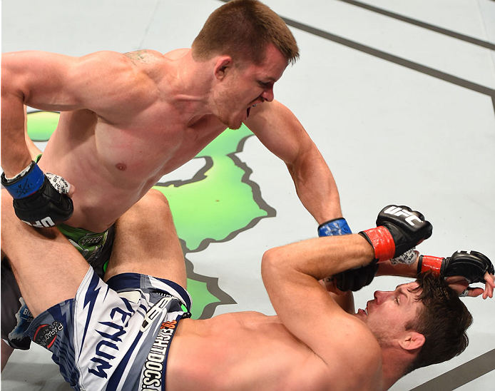 MONTREAL, QC - APRIL 25:   (L-R) CB Dollaway of the United States punches Michael Bisping of England in their middleweight bout during the UFC 186 event at the Bell Centre on April 25, 2015 in Montreal, Quebec, Canada. (Photo by Josh Hedges/Zuffa LLC/Zuff