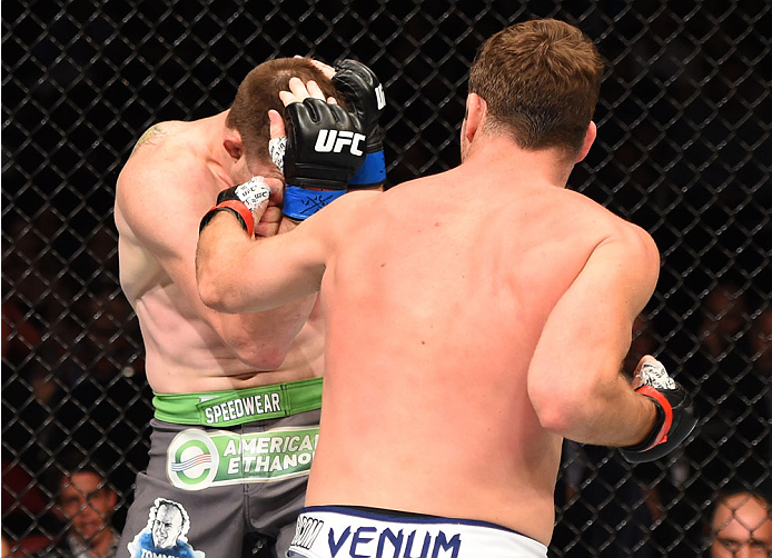 MONTREAL, QC - APRIL 25:   (R-L) Michael Bisping of England punches CB Dollaway of the United States in their middleweight bout during the UFC 186 event at the Bell Centre on April 25, 2015 in Montreal, Quebec, Canada. (Photo by Josh Hedges/Zuffa LLC/Zuff