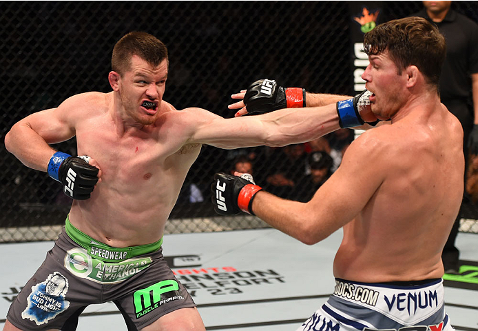 MONTREAL, QC - APRIL 25:   (L-R) CB Dollaway of the United States punches Michael Bisping of England in their middleweight bout during the UFC 186 event at the Bell Centre on April 25, 2015 in Montreal, Quebec, Canada. (Photo by Josh Hedges/Zuffa LLC/Zuff