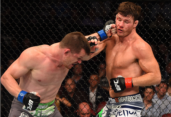 MONTREAL, QC - APRIL 25:   (L-R) CB Dollaway of the United States punches Michael Bisping of England in their middleweight bout during the UFC 186 event at the Bell Centre on April 25, 2015 in Montreal, Quebec, Canada. (Photo by Josh Hedges/Zuffa LLC/Zuff