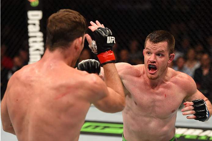 MONTREAL, QC - APRIL 25:   (R-L) CB Dollaway of the United States punches Michael Bisping of England in their middleweight bout during the UFC 186 event at the Bell Centre on April 25, 2015 in Montreal, Quebec, Canada. (Photo by Josh Hedges/Zuffa LLC/Zuff