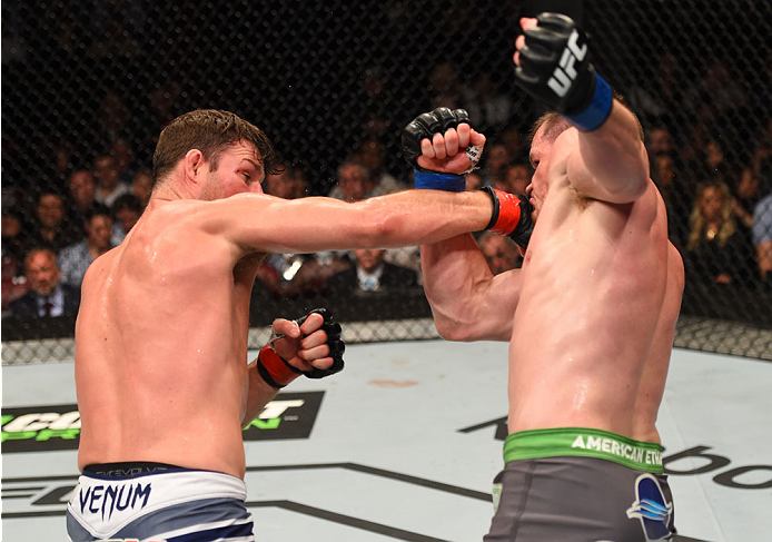 MONTREAL, QC - APRIL 25:   (L-R) Michael Bisping of England punches CB Dollaway of the United States in their middleweight bout during the UFC 186 event at the Bell Centre on April 25, 2015 in Montreal, Quebec, Canada. (Photo by Josh Hedges/Zuffa LLC/Zuff