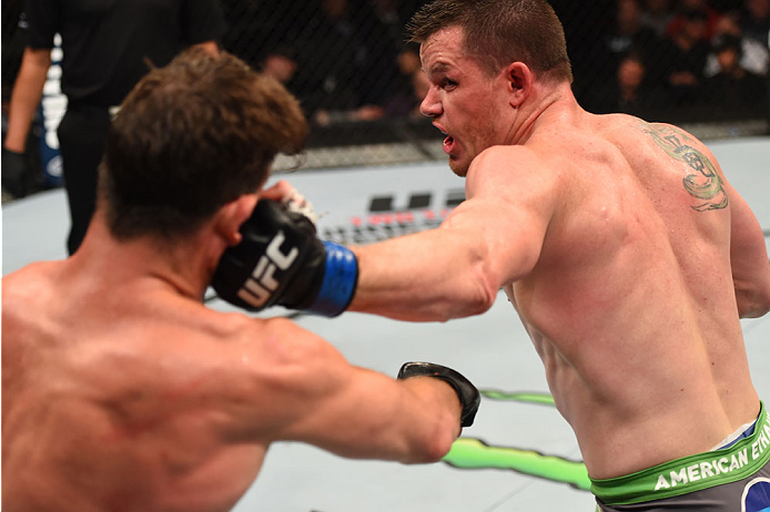 MONTREAL, QC - APRIL 25:   (R-L) CB Dollaway of the United States punches Michael Bisping of England in their middleweight bout during the UFC 186 event at the Bell Centre on April 25, 2015 in Montreal, Quebec, Canada. (Photo by Josh Hedges/Zuffa LLC/Zuff