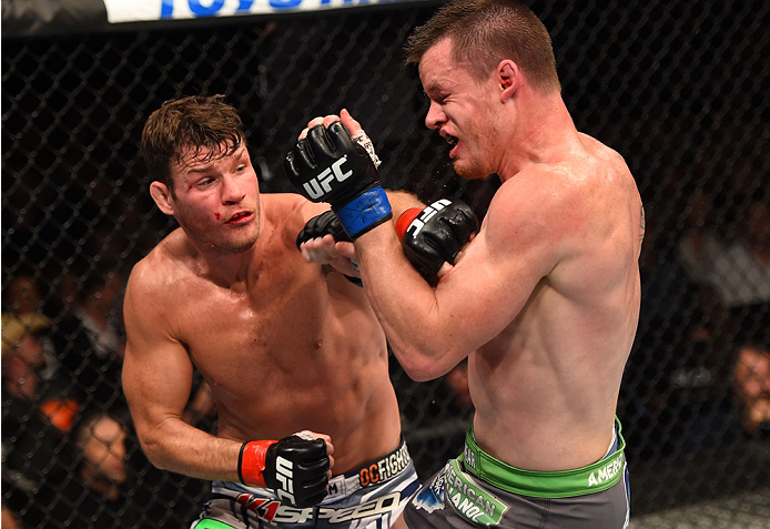 MONTREAL, QC - APRIL 25:   (L-R) Michael Bisping of England punches CB Dollaway of the United States in their middleweight bout during the UFC 186 event at the Bell Centre on April 25, 2015 in Montreal, Quebec, Canada. (Photo by Josh Hedges/Zuffa LLC/Zuff