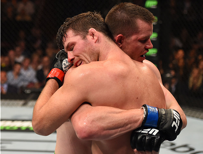 MONTREAL, QC - APRIL 25:   (L-R) Michael Bisping of England and CB Dollaway of the United States embrace after their middleweight bout during the UFC 186 event at the Bell Centre on April 25, 2015 in Montreal, Quebec, Canada. (Photo by Josh Hedges/Zuffa L