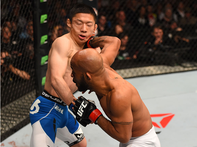 MONTREAL, QC - APRIL 25: (R-L) Demetrious Johnson of the United States punches Kyoji Horiguchi of Japan in their UFC flyweight championship bout during the UFC 186 event at the Bell Centre on April 25, 2015 in Montreal, Quebec, Canada. (Photo by Josh He