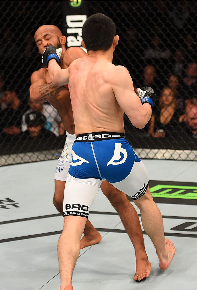 MONTREAL, QC - APRIL 25:   (R-L) Kyoji Horiguchi of Japan punches Demetrious Johnson of the United States in their UFC flyweight championship bout during the UFC 186 event at the Bell Centre on April 25, 2015 in Montreal, Quebec, Canada. (Photo by Josh He