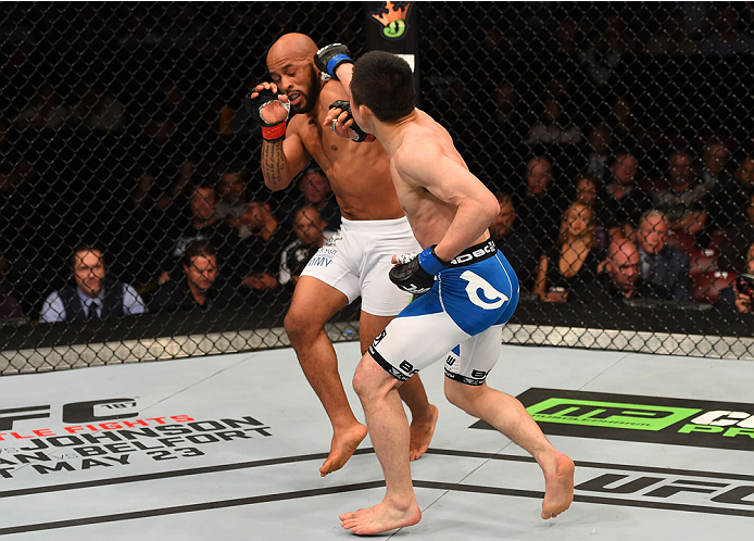 MONTREAL, QC - APRIL 25:   (R-L) Kyoji Horiguchi of Japan punches Demetrious Johnson of the United States in their UFC flyweight championship bout during the UFC 186 event at the Bell Centre on April 25, 2015 in Montreal, Quebec, Canada. (Photo by Josh He