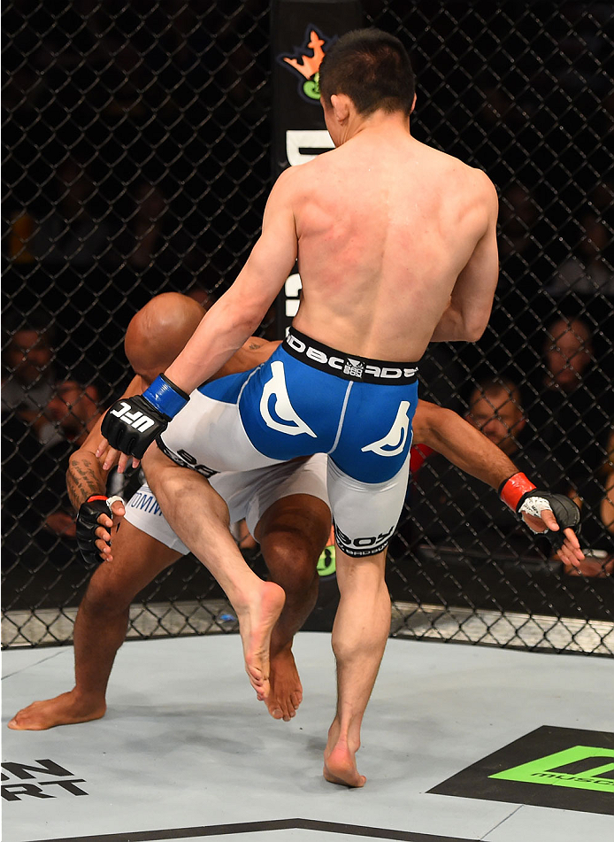 MONTREAL, QC - APRIL 25:   (R-L) Kyoji Horiguchi of Japan knees Demetrious Johnson of the United States in their UFC flyweight championship bout during the UFC 186 event at the Bell Centre on April 25, 2015 in Montreal, Quebec, Canada. (Photo by Josh Hedg