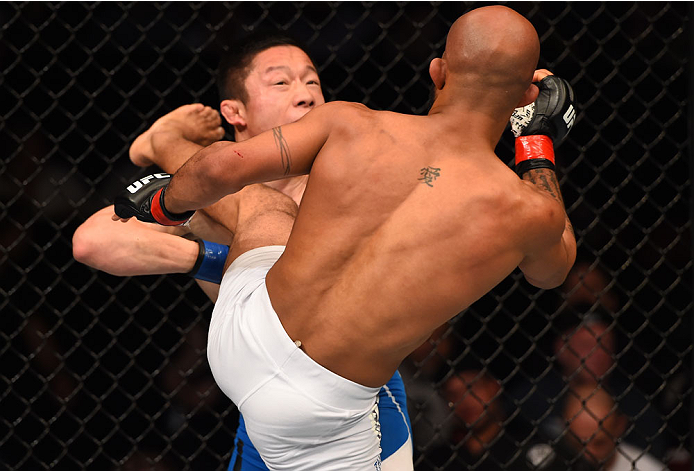 MONTREAL, QC - APRIL 25:   (R-L) Demetrious Johnson of the United States kicks Kyoji Horiguchi of Japan in their UFC flyweight championship bout during the UFC 186 event at the Bell Centre on April 25, 2015 in Montreal, Quebec, Canada. (Photo by Josh Hedg