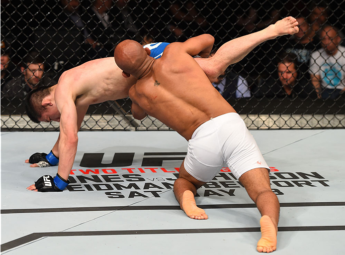 MONTREAL, QC - APRIL 25: (R-L) Demetrious Johnson of the United States takes down Kyoji Horiguchi of Japan in their UFC flyweight championship bout during the UFC 186 event at the Bell Centre on April 25, 2015 in Montreal, Quebec, Canada. (Photo by Josh