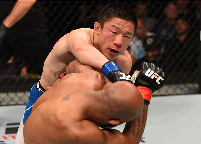 MONTREAL, QC - APRIL 25:   (L-R) Kyoji Horiguchi of Japan punches Demetrious Johnson of the United States in their UFC flyweight championship bout during the UFC 186 event at the Bell Centre on April 25, 2015 in Montreal, Quebec, Canada. (Photo by Josh He