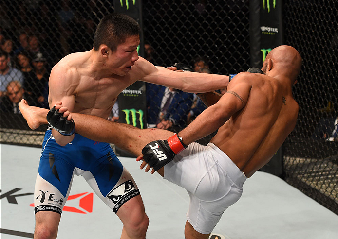 MONTREAL, QC - APRIL 25:   (L-R) Kyoji Horiguchi of Japan punches Demetrious Johnson of the United States in their UFC flyweight championship bout during the UFC 186 event at the Bell Centre on April 25, 2015 in Montreal, Quebec, Canada. (Photo by Josh He