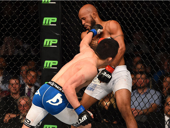 MONTREAL, QC - APRIL 25:   (L-R) Kyoji Horiguchi of Japan punches Demetrious Johnson of the United States in their UFC flyweight championship bout during the UFC 186 event at the Bell Centre on April 25, 2015 in Montreal, Quebec, Canada. (Photo by Josh He