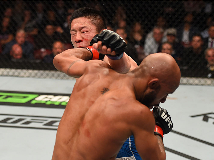 MONTREAL, QC - APRIL 25:   (R-L) Demetrious Johnson of the United States punches Kyoji Horiguchi of Japan in their UFC flyweight championship bout during the UFC 186 event at the Bell Centre on April 25, 2015 in Montreal, Quebec, Canada. (Photo by Josh He