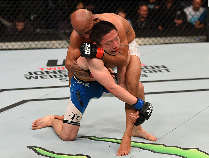 MONTREAL, QC - APRIL 25: (R-L) Demetrious Johnson of the United States attempts a rear choke submission against Kyoji Horiguchi of Japan in their UFC flyweight championship bout during the UFC 186 event at the Bell Centre on April 25, 2015 in Montreal,