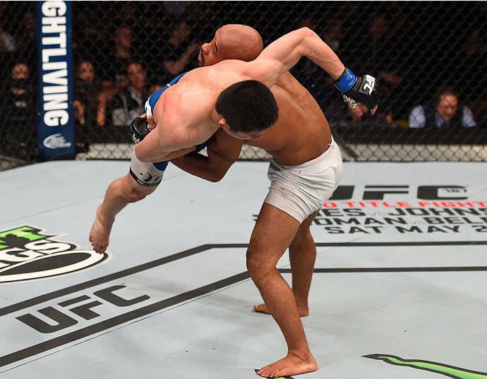 MONTREAL, QC - APRIL 25: (R-L) Demetrious Johnson of the United States takes down Kyoji Horiguchi of Japan in their UFC flyweight championship bout during the UFC 186 event at the Bell Centre on April 25, 2015 in Montreal, Quebec, Canada. (Photo by Josh