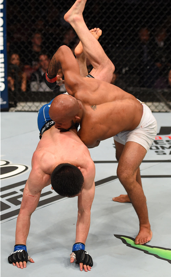 MONTREAL, QC - APRIL 25:   (R-L) Demetrious Johnson of the United States takes down Kyoji Horiguchi of Japan in their UFC flyweight championship bout during the UFC 186 event at the Bell Centre on April 25, 2015 in Montreal, Quebec, Canada. (Photo by Josh