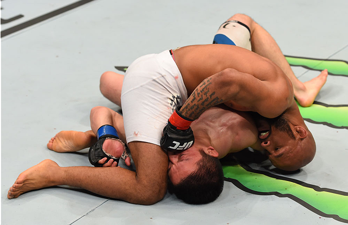 MONTREAL, QC - APRIL 25:   Demetrious Johnson (top) punches Kyoji Horiguchi in their UFC flyweight championship bout during the UFC 186 event at the Bell Centre on April 25, 2015 in Montreal, Quebec, Canada. (Photo by Josh Hedges/Zuffa LLC/Zuffa LLC via G