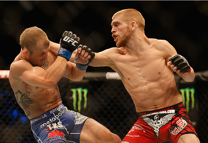 LAS VEGAS, NV - MAY 23:  (R-L) Justin Scoggins punches Joshua Sampo in their flyweight bout during the UFC 187 event at the MGM Grand Garden Arena on May 23, 2015 in Las Vegas, Nevada.  (Photo by Christian Petersen/Zuffa LLC/Zuffa LLC via Getty Images)