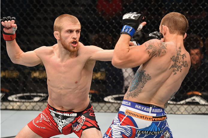 LAS VEGAS, NV - MAY 23:  (L-R) Justin Scoggins punches Joshua Sampo in their flyweight bout during the UFC 187 event at the MGM Grand Garden Arena on May 23, 2015 in Las Vegas, Nevada.  (Photo by Josh Hedges/Zuffa LLC/Zuffa LLC via Getty Images)