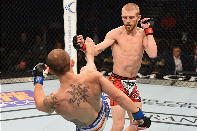 LAS VEGAS, NV - MAY 23: (L-R) Joshua Sampo kicks Justin Scoggins in their flyweight bout during the UFC 187 event at the MGM Grand Garden Arena on May 23, 2015 in Las Vegas, Nevada.  (Photo by Josh Hedges/Zuffa LLC/Zuffa LLC via Getty Images)